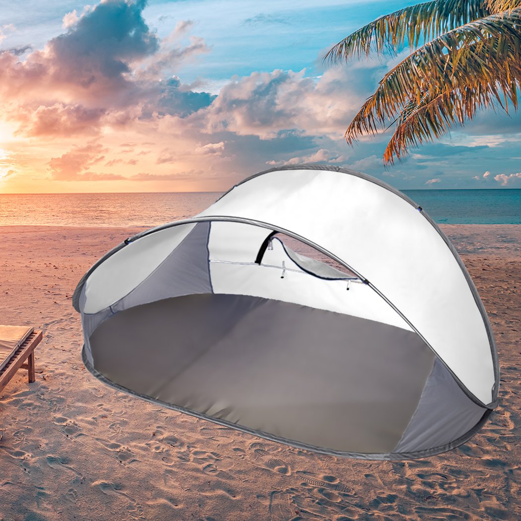 Mountvie Pop Up Tent set up at the beach, spacious enough for four people, featuring a grey color and interwoven mesh for ventilation.